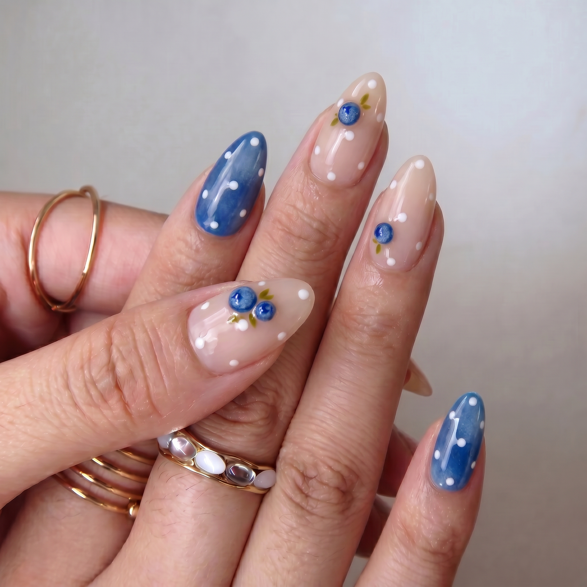 Berry Bubble press-on nails worn on hand – almond shape by Handora