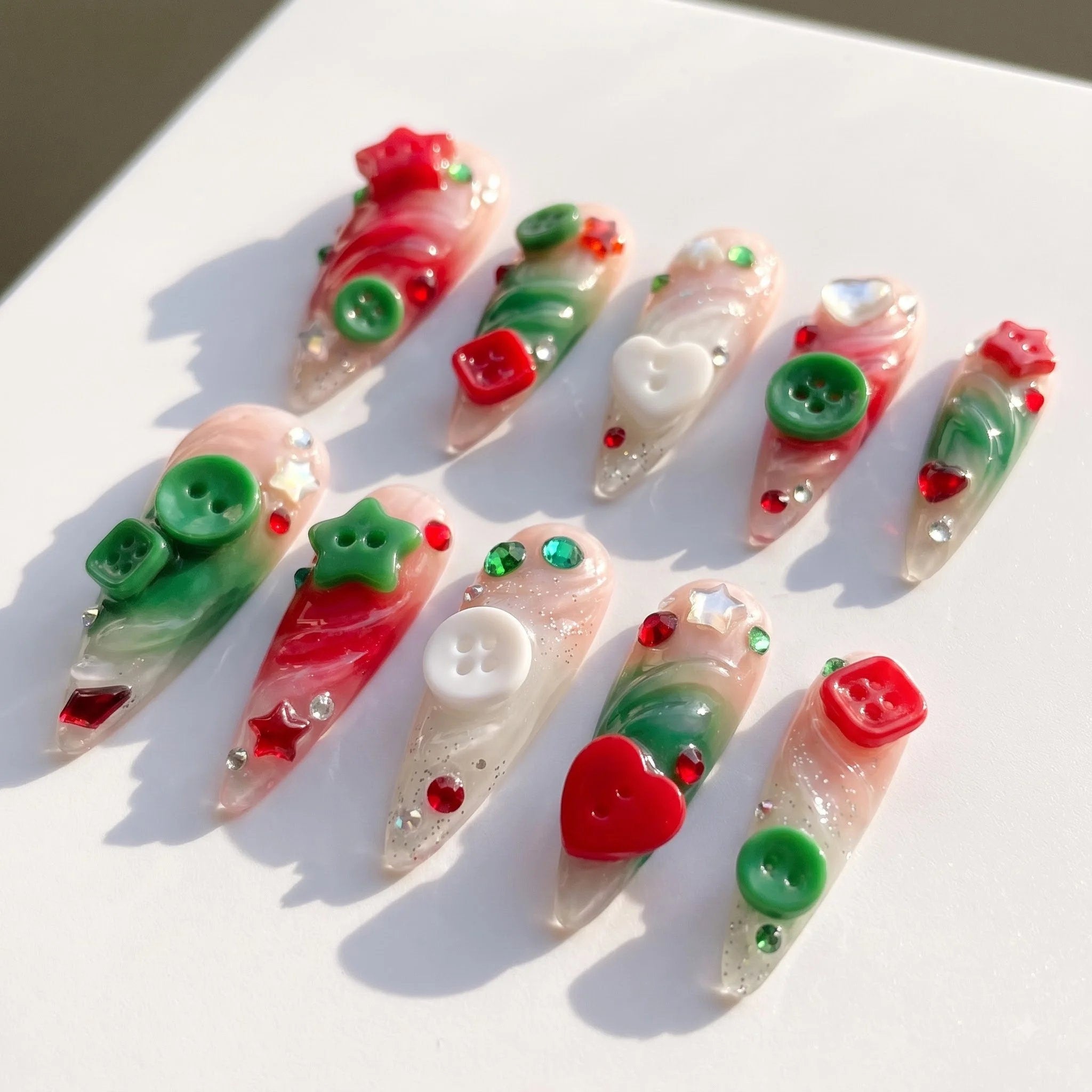 Button Knit christmas press-on nails – flat lay and packaging by Handora Nails