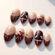 Crimson Web Christmas press-on nails – flat lay by Handora Nails