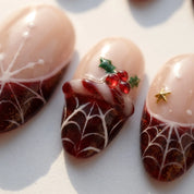 Crimson Web Christmas press-on nails – close-up by Handora Nails
