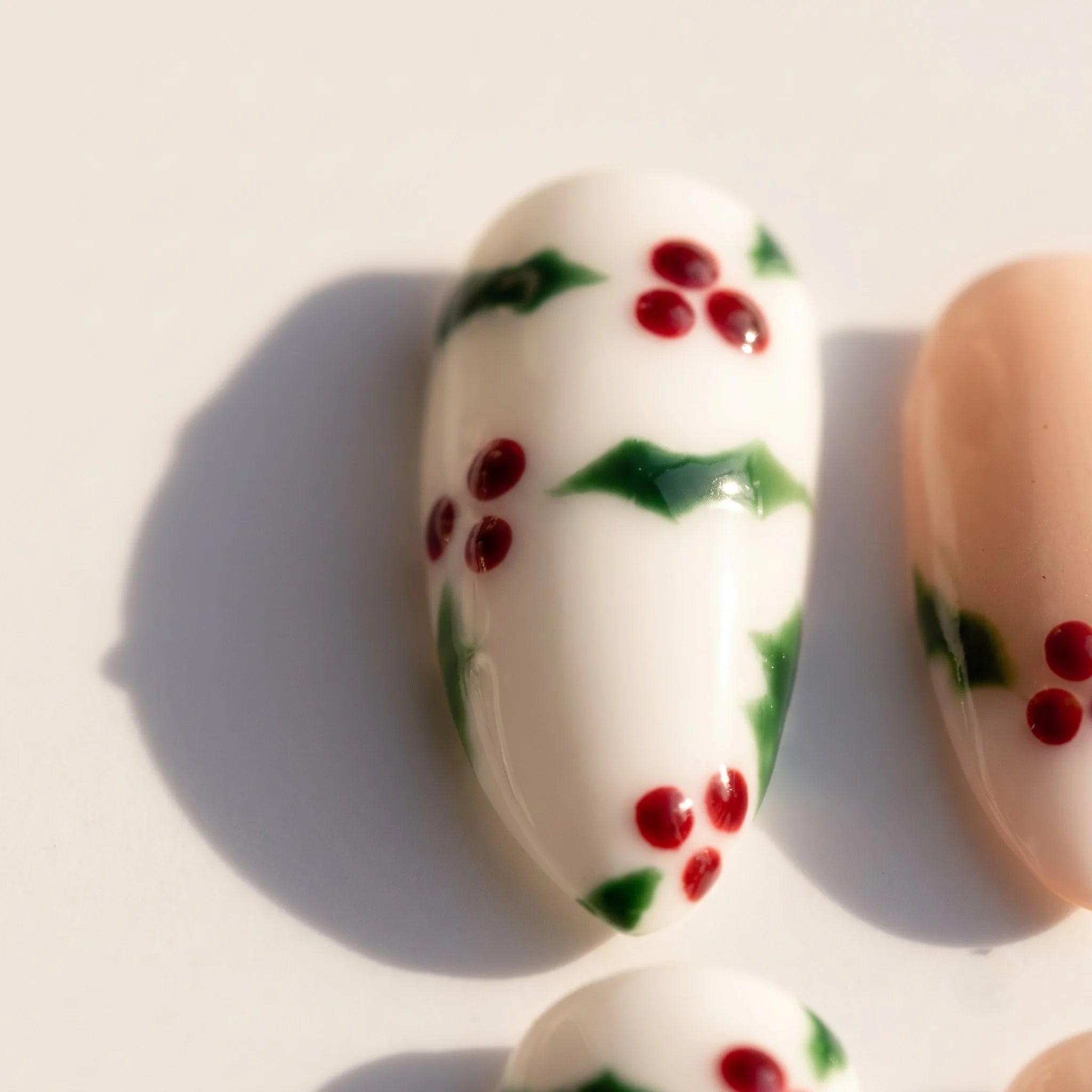 Holly Berry Christmas press-on nails – close-up by Handora Nails