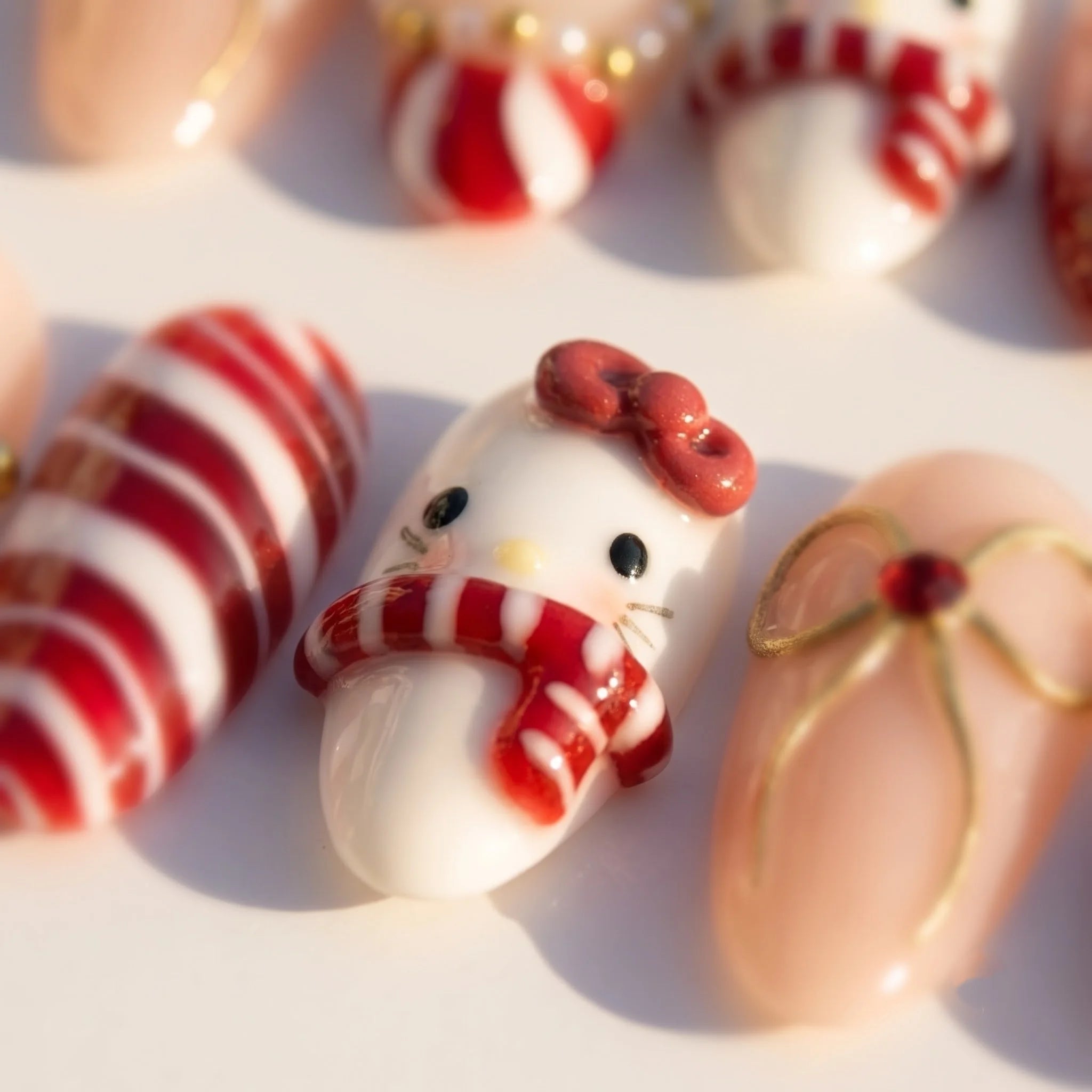 Merry Kitty Candy Cane press-on nails – close-up by Handora Nails