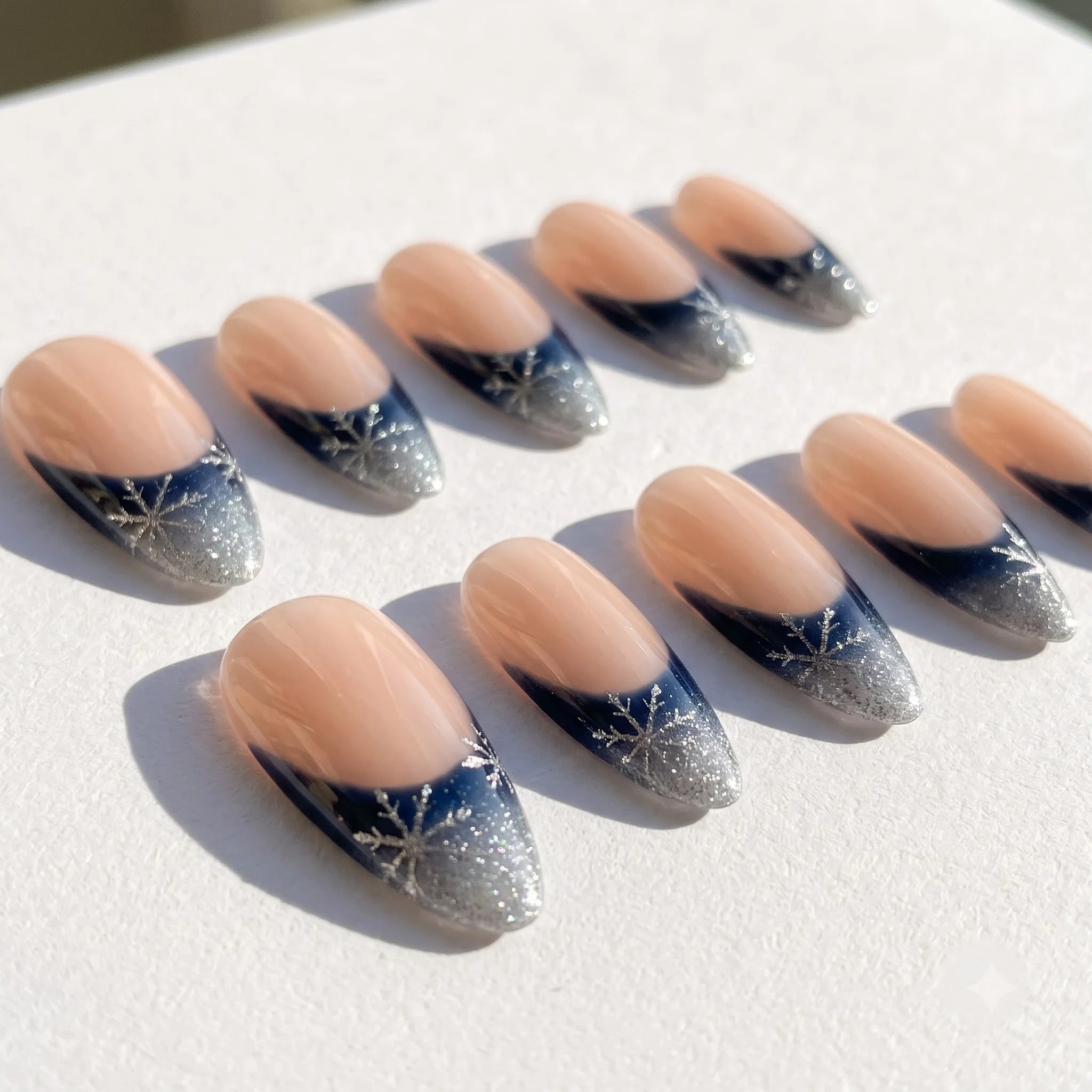 Winter Midnight snowflake press-on nails – flat lay and packaging by Handora Nails