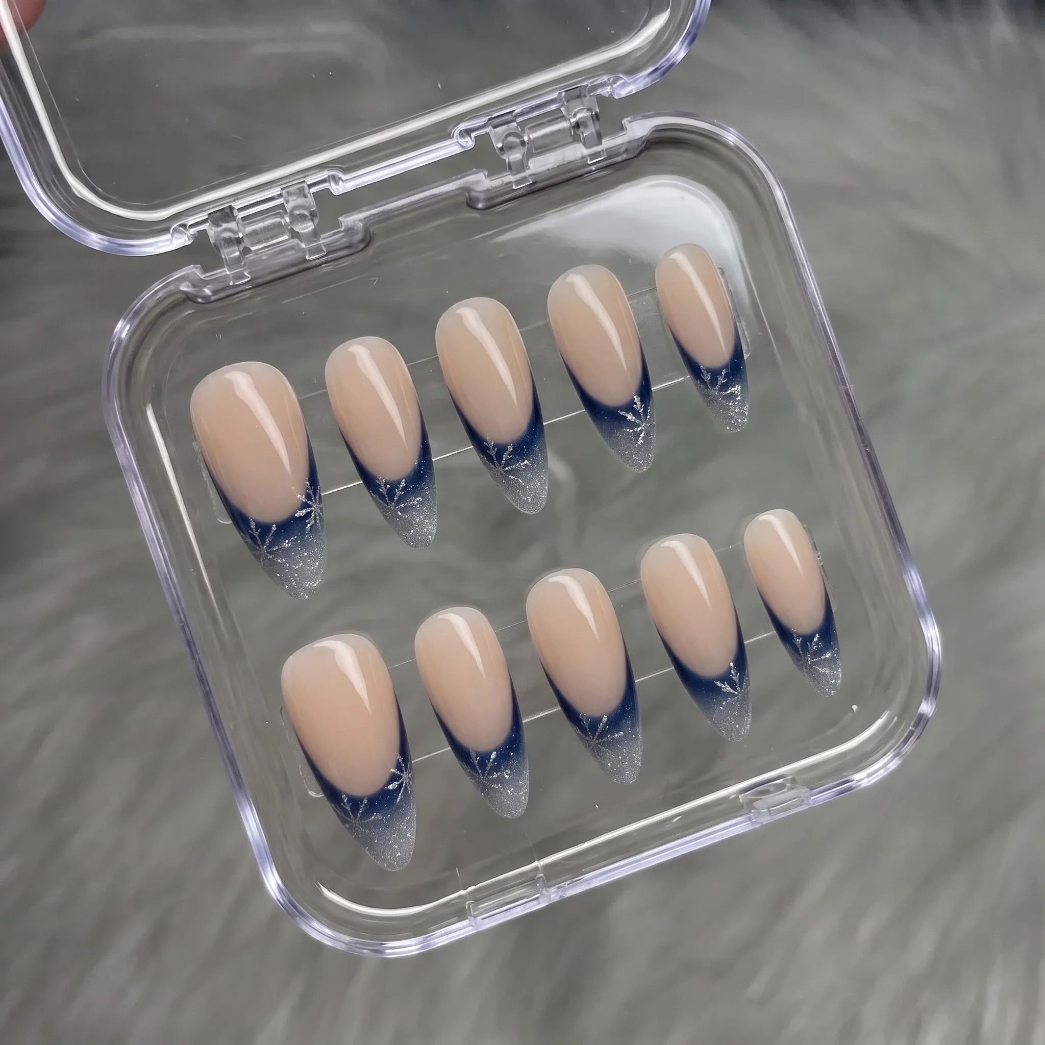 Winter Midnight snowflake press-on nails – flat lay and packaging by Handora Nails
