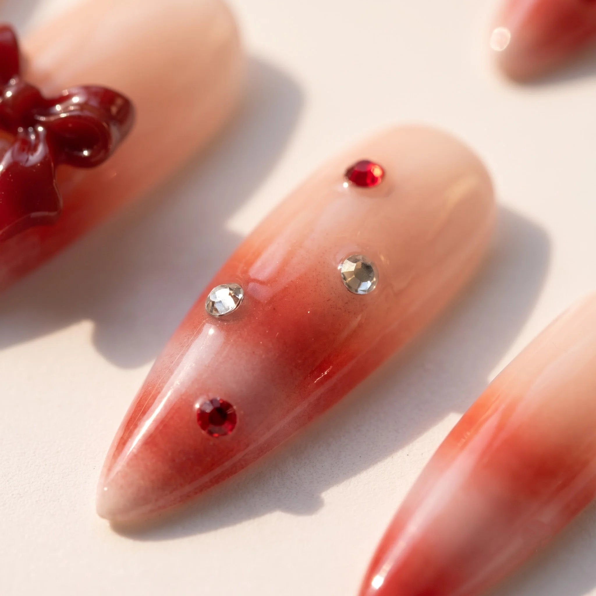 Woolen Bow christmas press-on nails – close-up by Handora Nails
