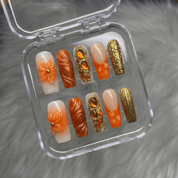Amber Bloom press-on nails worn on hand – almond shape by Handora