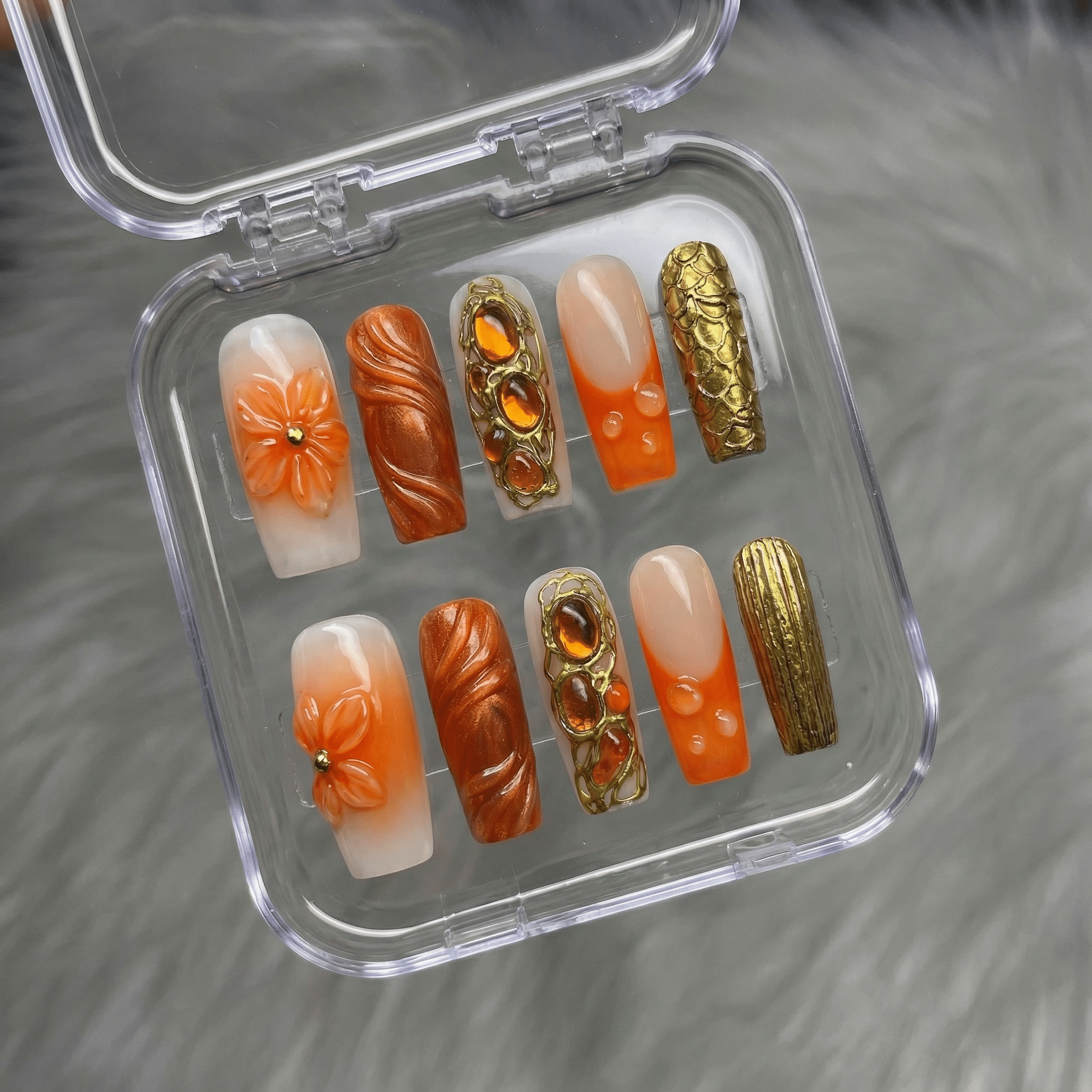 Amber Bloom press-on nails worn on hand – almond shape by Handora