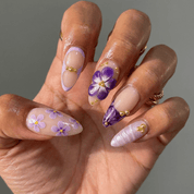 Amethyst Bloom press-on nails worn on hand – almond shape by Handora