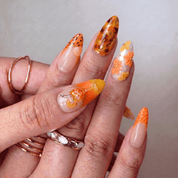 Aperol Spritz press-on nails worn on hand – almond shape by Handora
