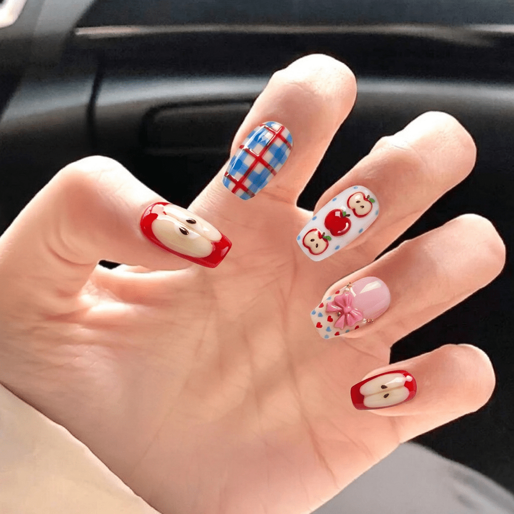 Apple Ribbon press-on nails worn on hand – almond shape by Handora