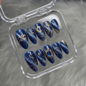 Aqua Cosmic press-on nails worn on hand – almond shape by Handora