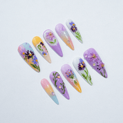 Aster Bloom press-on nails worn on hand – almond shape by Handora