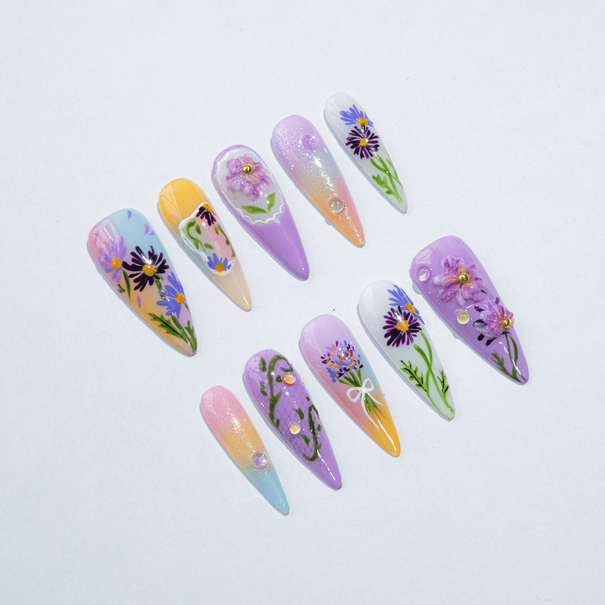 Aster Bloom press-on nails worn on hand – almond shape by Handora