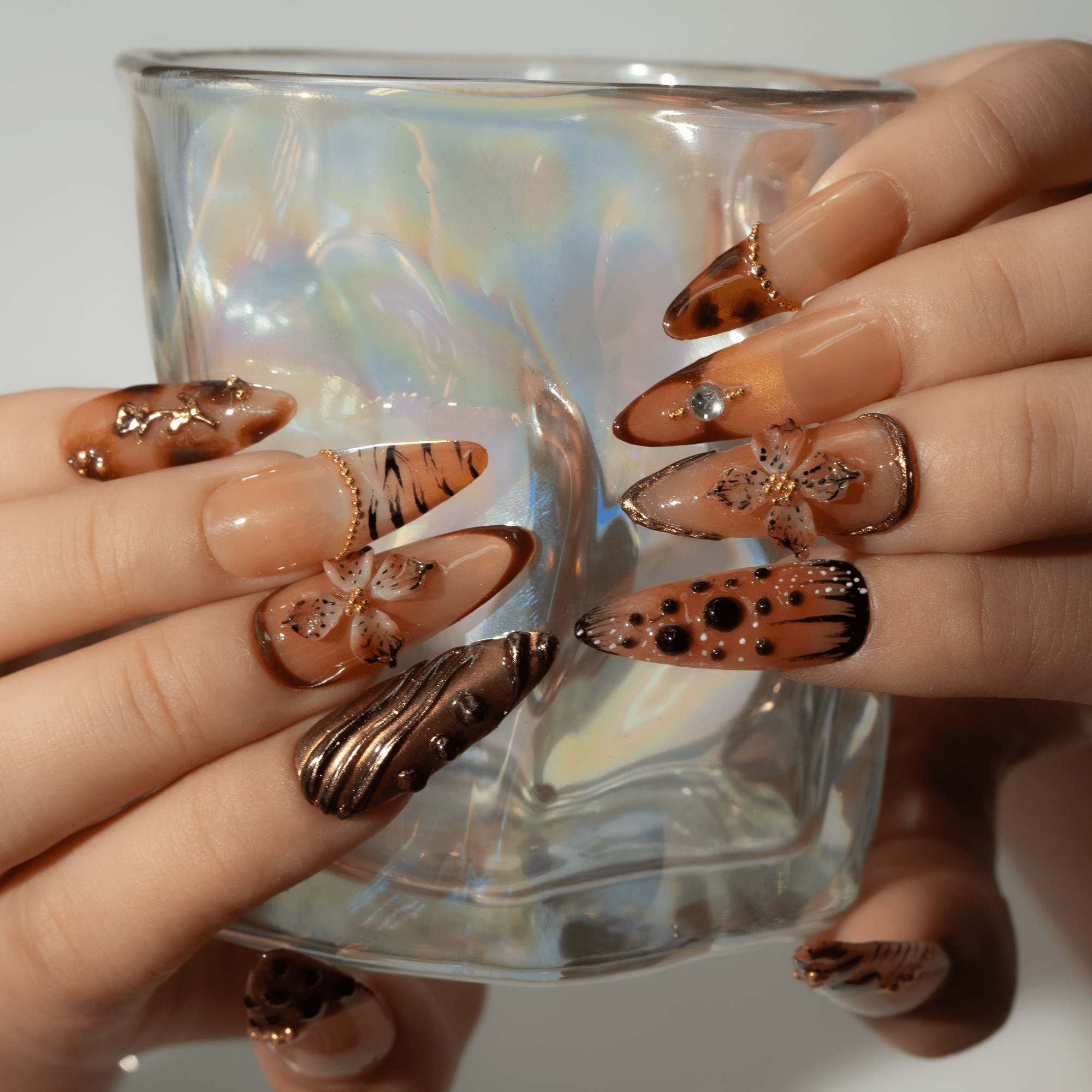 Autumn Blossom press-on nails worn on hand – almond shape by Handora