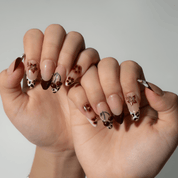 Autumn Cherry press-on nails worn on hand – almond shape by Handora