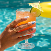 Azure Floral press-on nails worn on hand – coffin shape by Handora