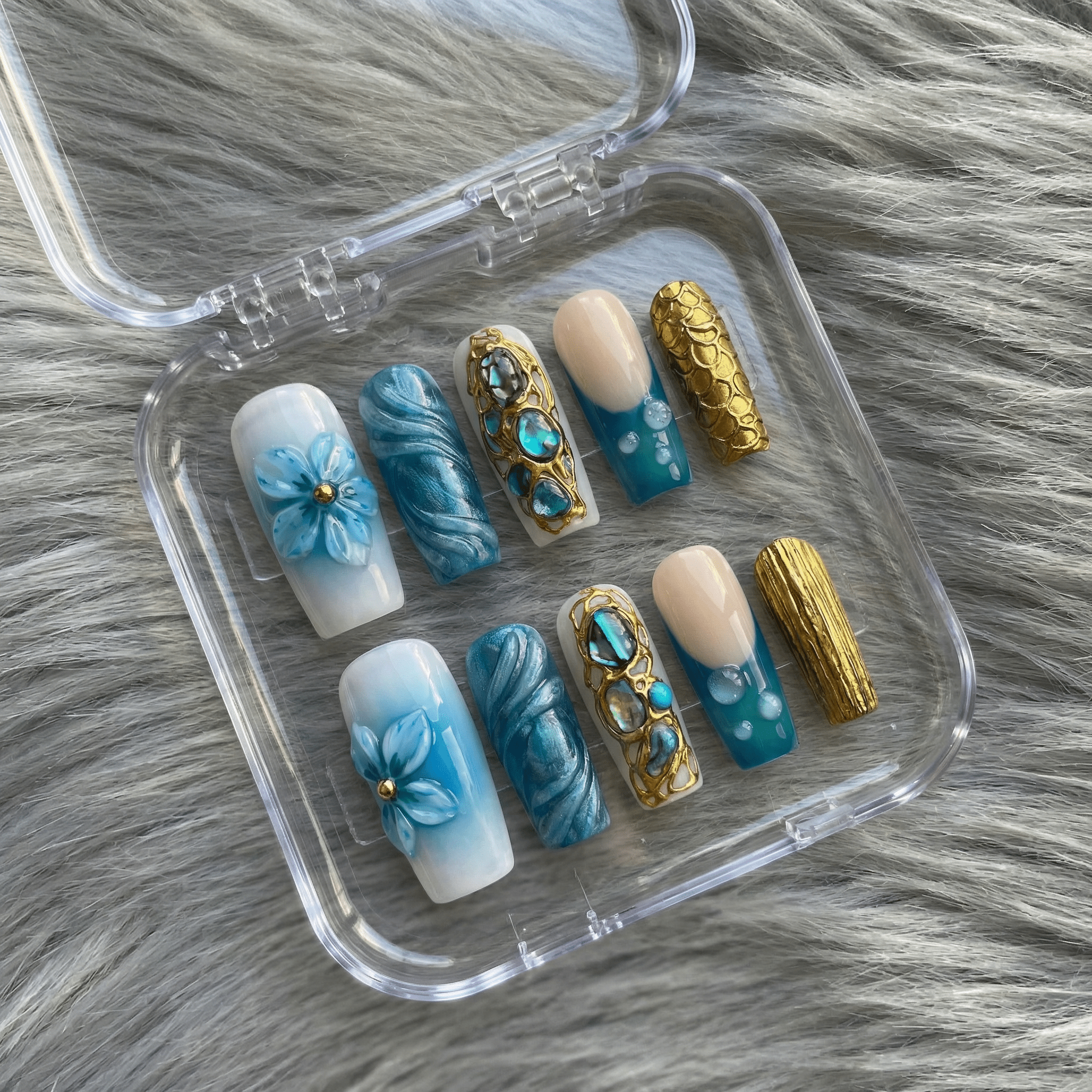 Azure Gilded press-on nails worn on hand – almond shape by Handora