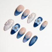 Azure Shell press-on nails worn on hand – almond shape by Handora