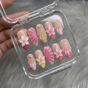 Blossom Aura press-on nails worn on hand – almond shape by Handora