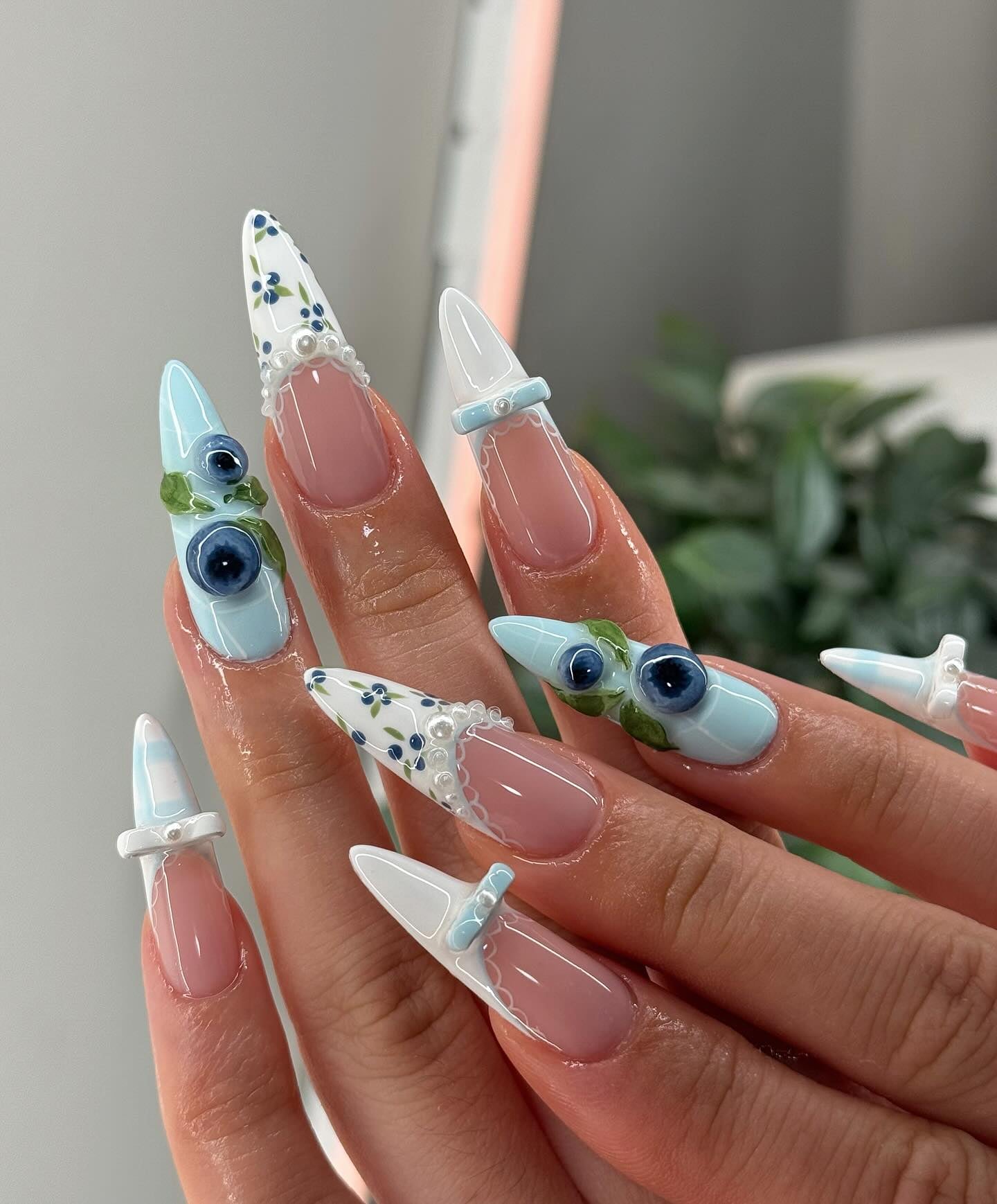 Blueberry Bows press-on nails worn on hand – almond shape by Handora