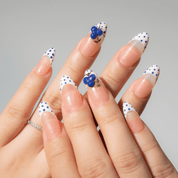 Blueberry Dot press-on nails worn on hand – almond shape by Handora