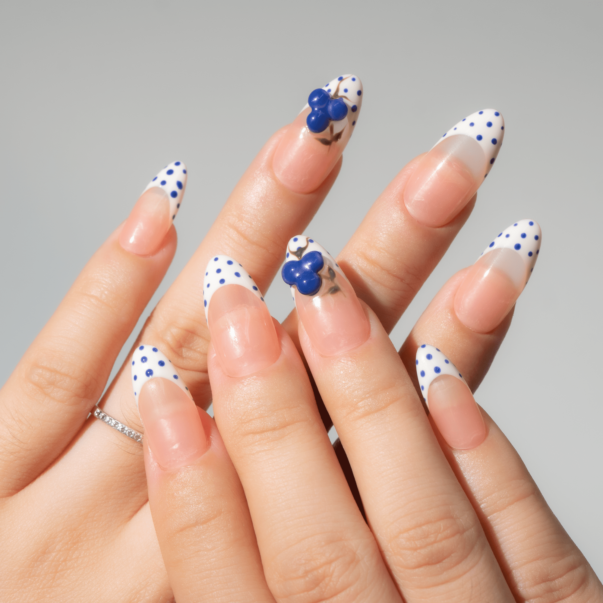 Blueberry Dot press-on nails worn on hand – almond shape by Handora