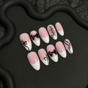 Blush Ribbon press-on nails worn on hand – almond shape by Handora