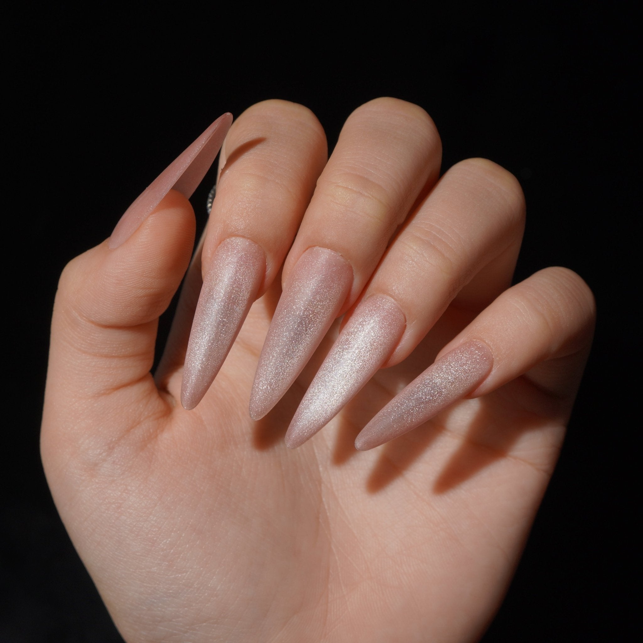 Blushveil press-on nails worn on hand – almond shape by Handora