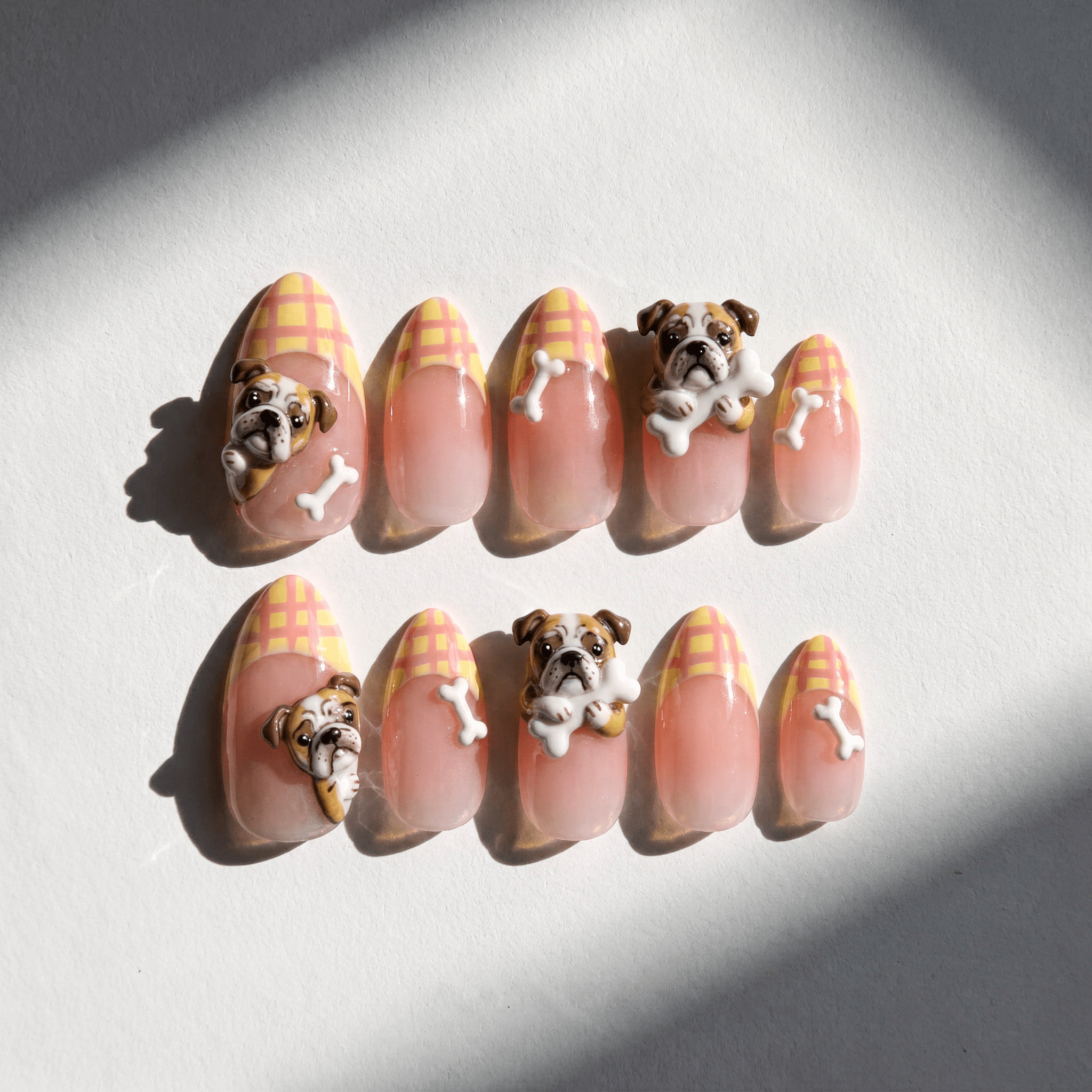 Bulldog Plaid press-on nails worn on hand – almond shape by Handora
