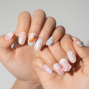 Bunny Garden press-on nails worn on hand – oval shape by Handora