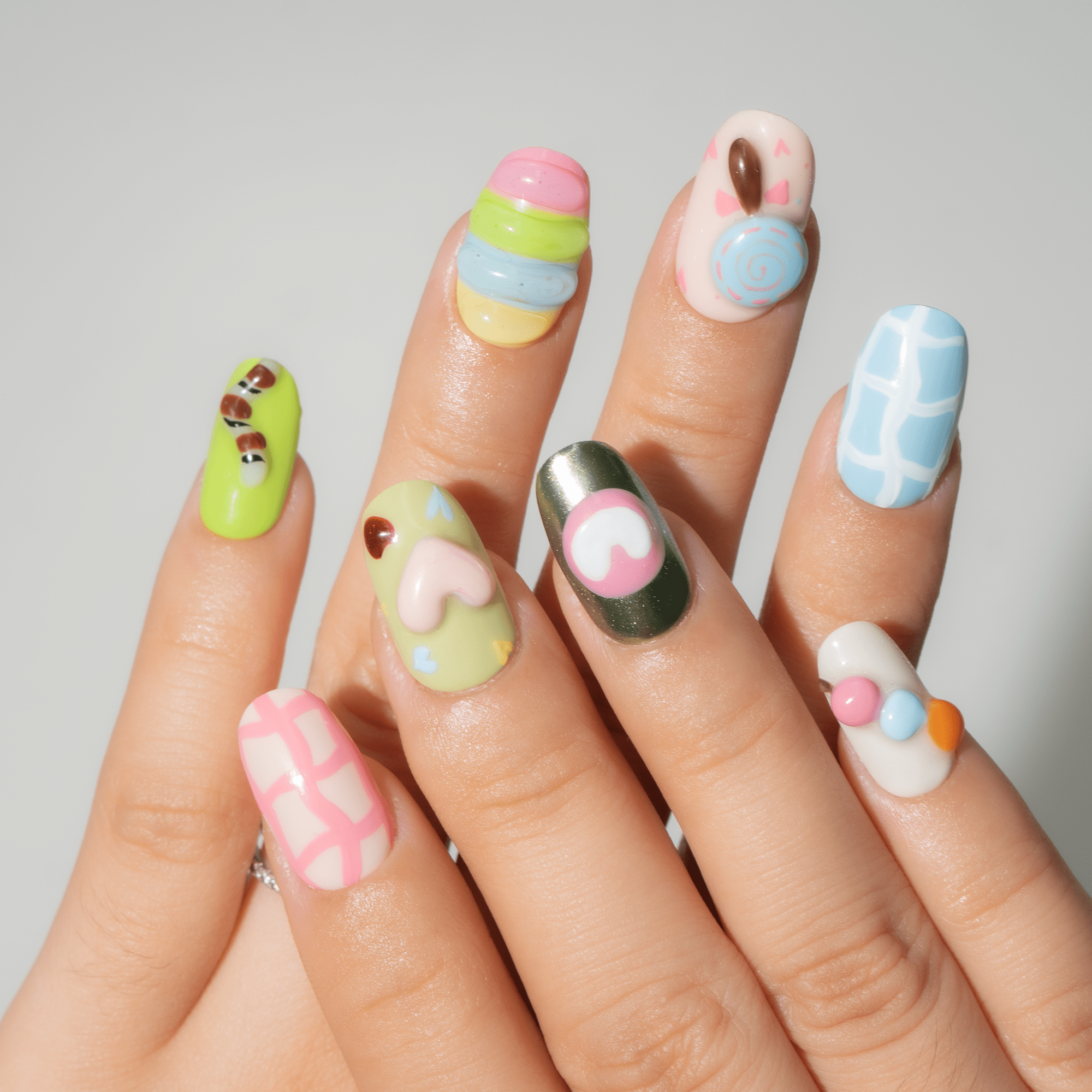 Candy Cloud press-on nails worn on hand – oval shape by Handora