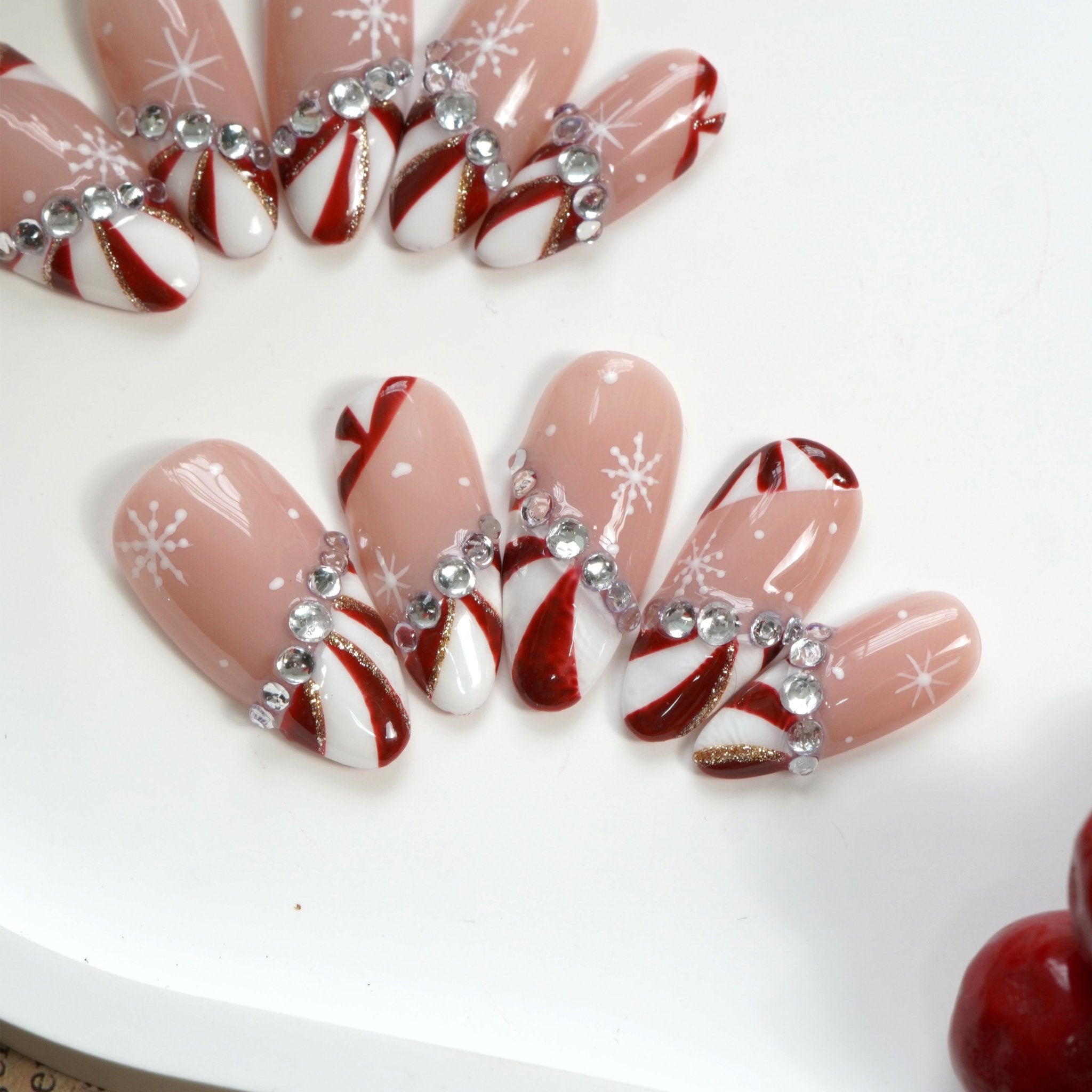 Candy Glam press-on nails worn on hand – almond shape by Handora