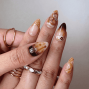 Caramel Macchiato press-on nails worn on hand – almond shape by Handora