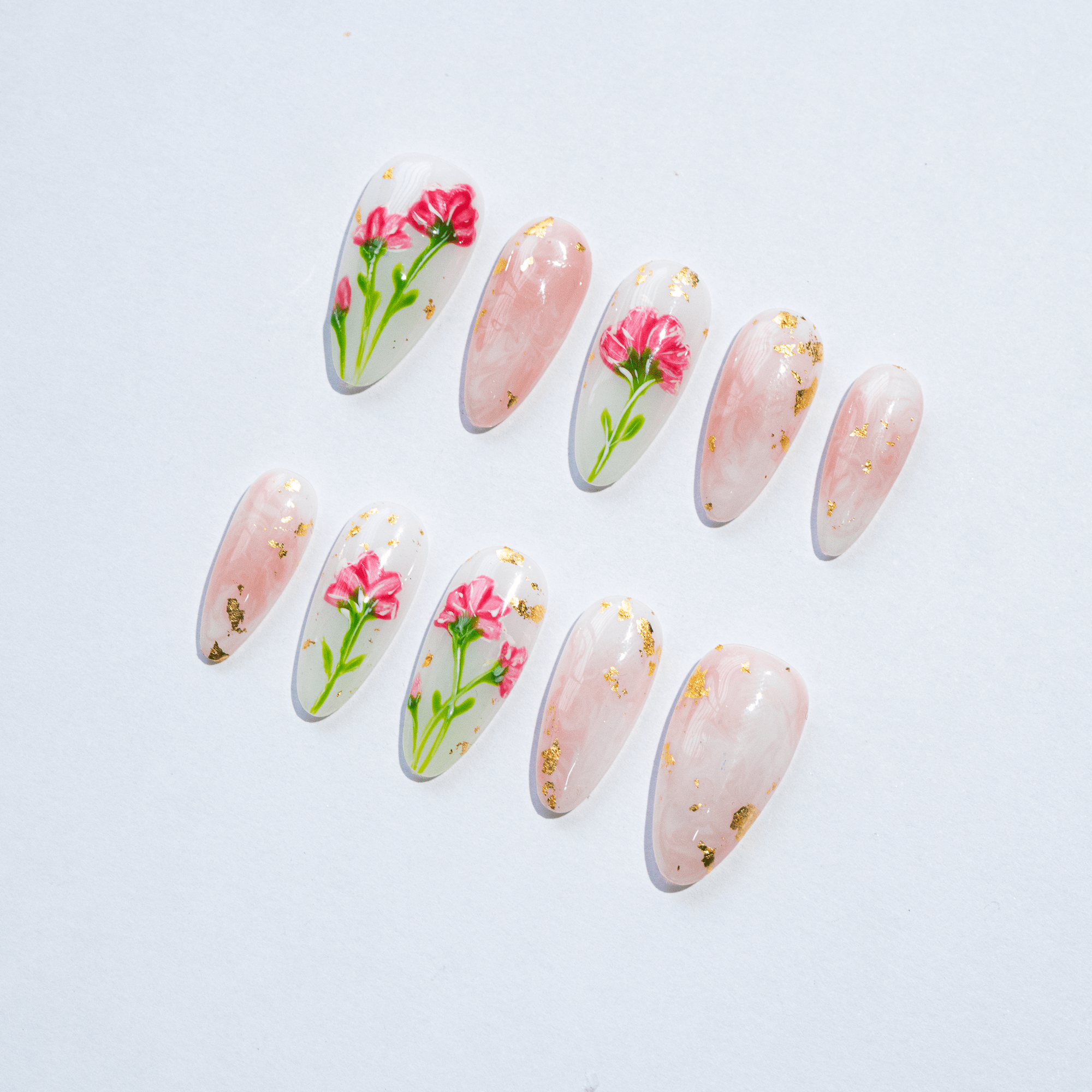 Carnation Bloom press-on nails worn on hand – almond shape by Handora