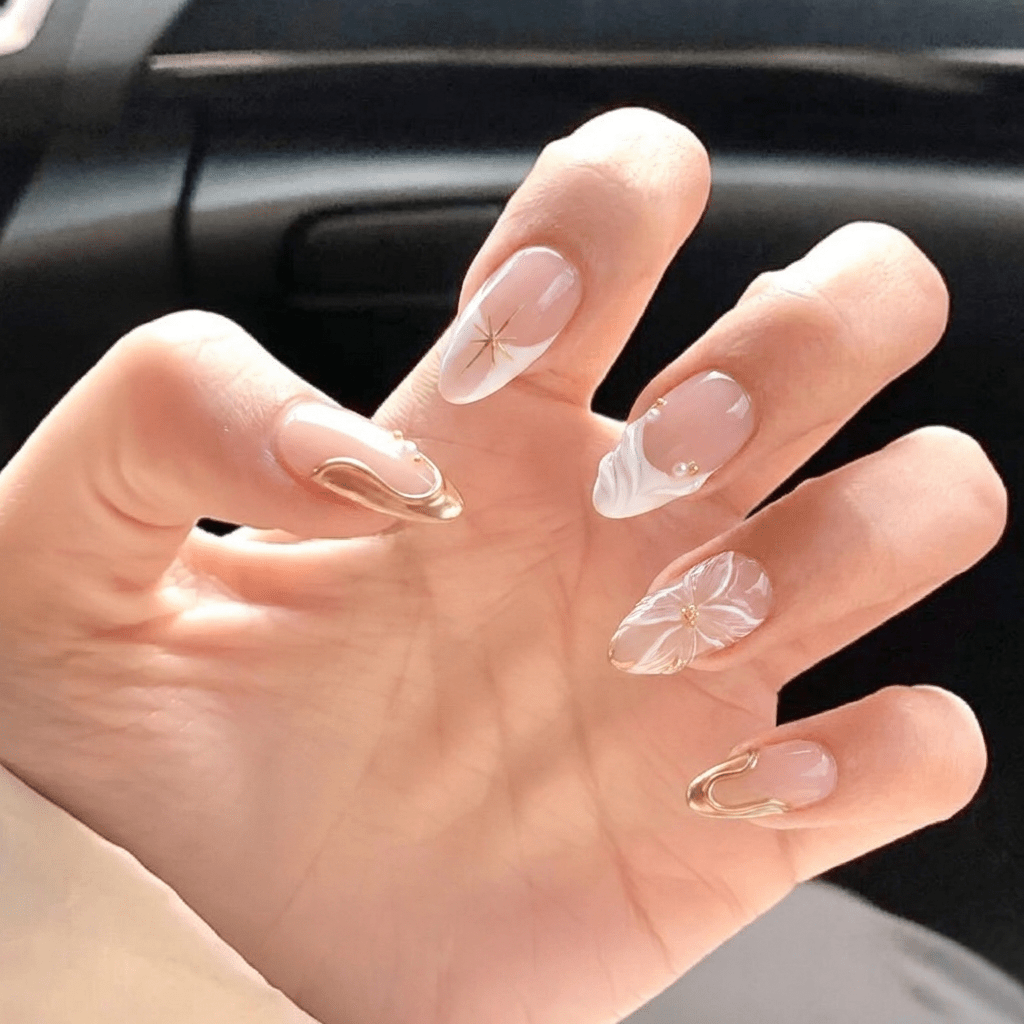 Celestial Bloom press-on nails worn on hand – almond shape by Handora