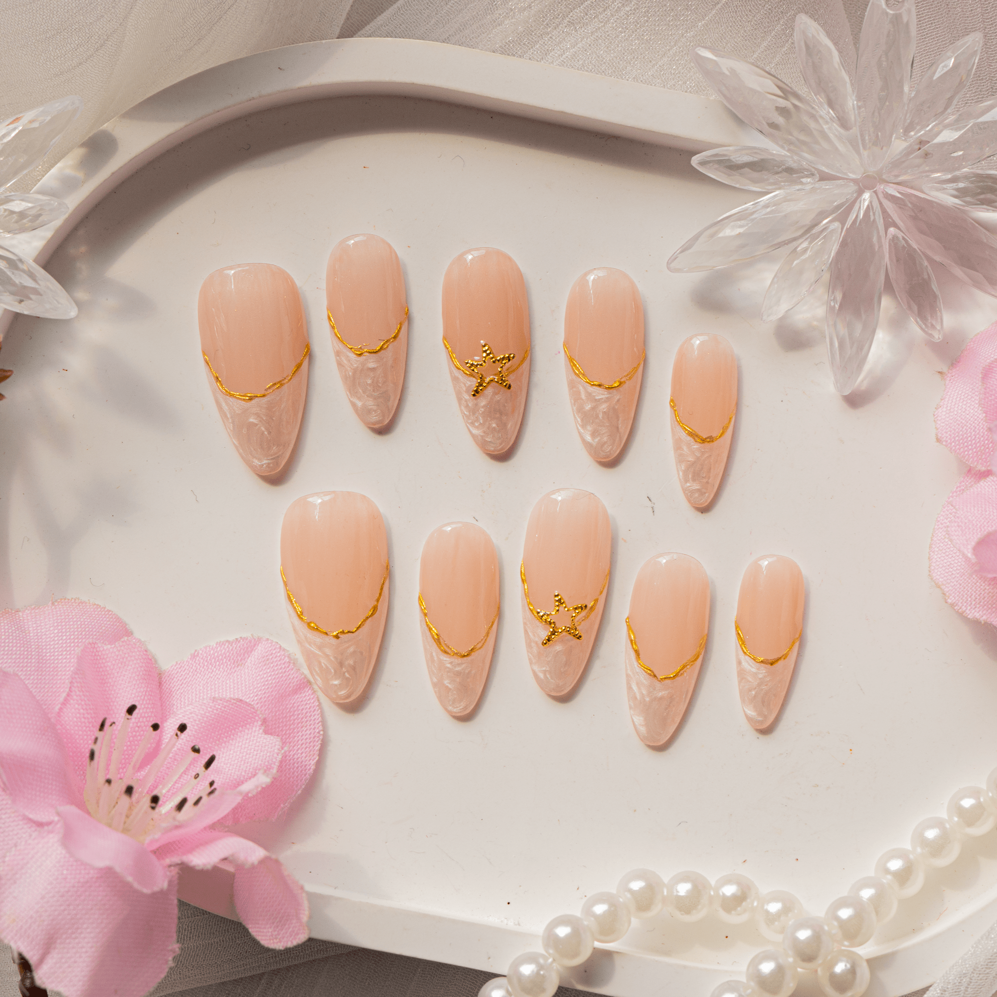 Celestial Marble press-on nails worn on hand – almond shape by Handora