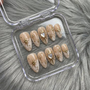 Celestial Nude press-on nails worn on hand – almond shape by Handora