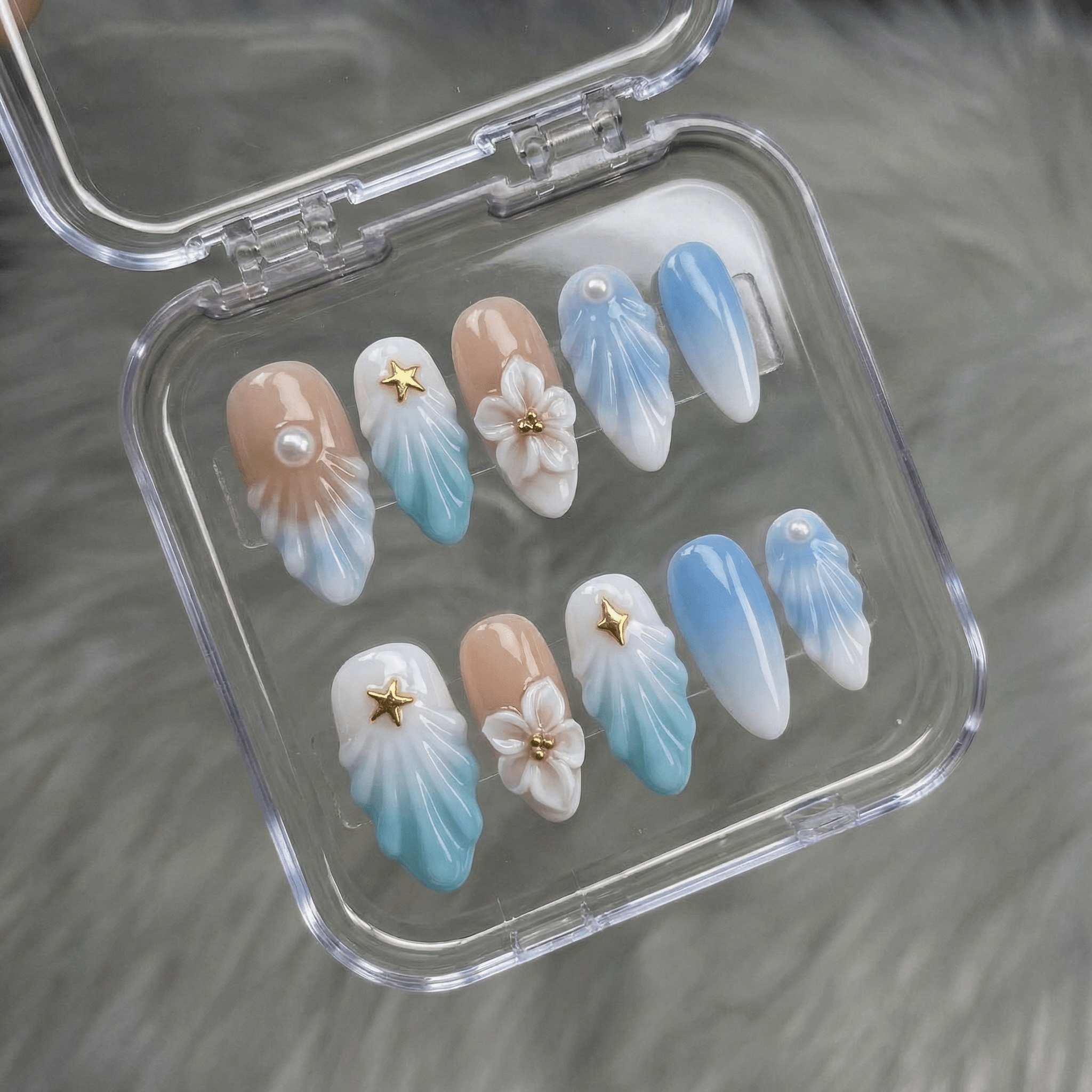 Celestial Tide press-on nails worn on hand – almond shape by Handora