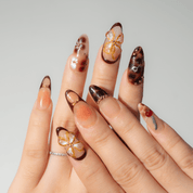 Cherry Bloom press-on nails worn on hand – almond shape by Handora