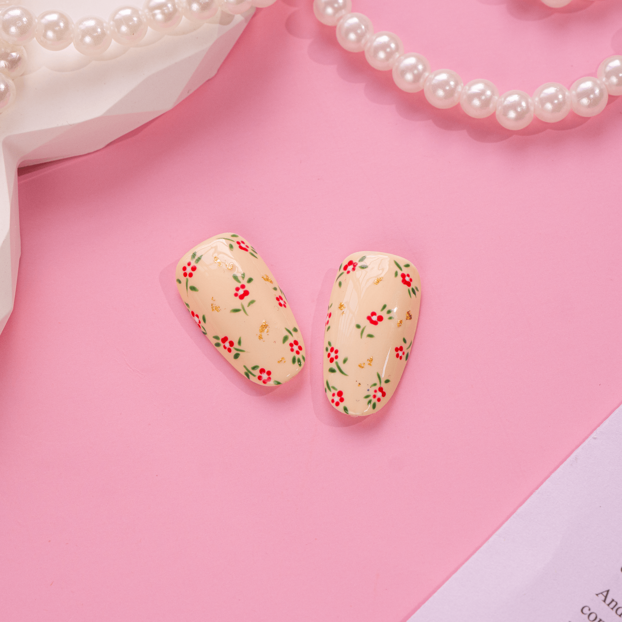 Cherry Coquette press-on nails worn on hand – almond shape by Handora