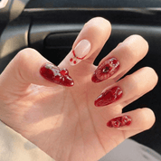 Cherry Crush press-on nails worn on hand – almond shape by Handora