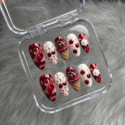 Cherry Sundae press-on nails worn on hand – almond shape by Handora