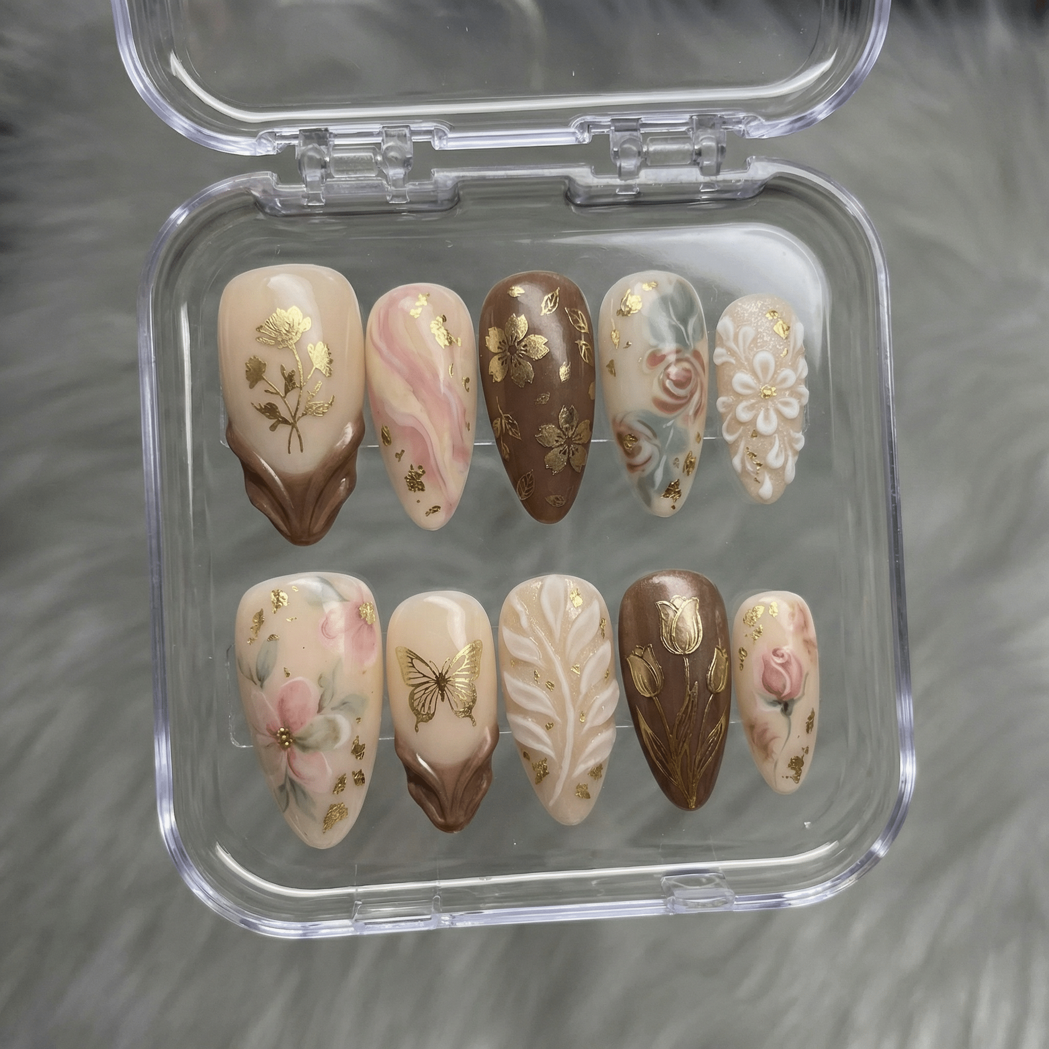 Choco Bloom press-on nails worn on hand – almond shape by Handora