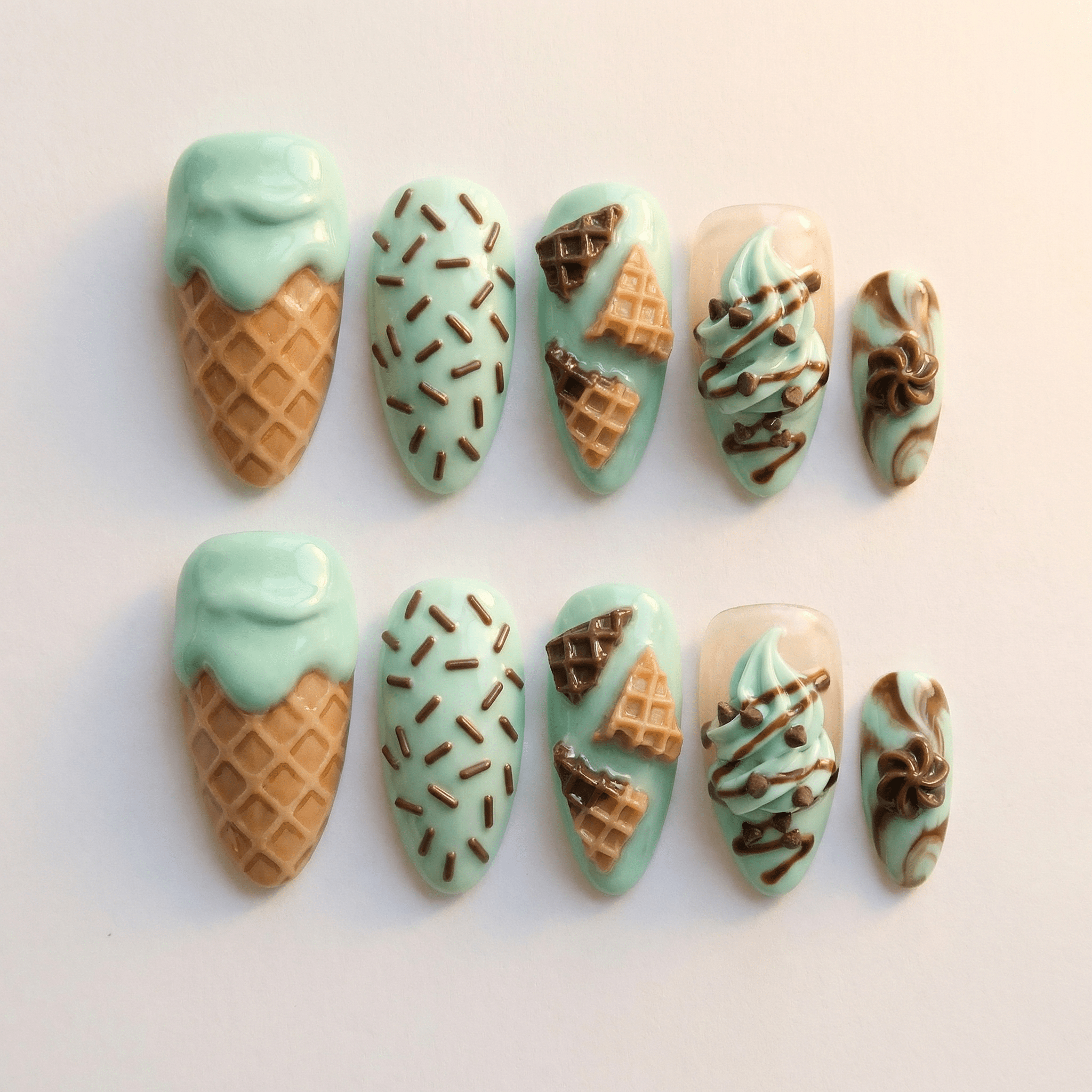 Choco Mint press-on nails worn on hand – almond shape by Handora