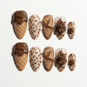 Choco Swirl press-on nails worn on hand – almond shape by Handora