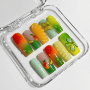 Citrus Bloom press-on nails worn on hand – coffin shape by Handora