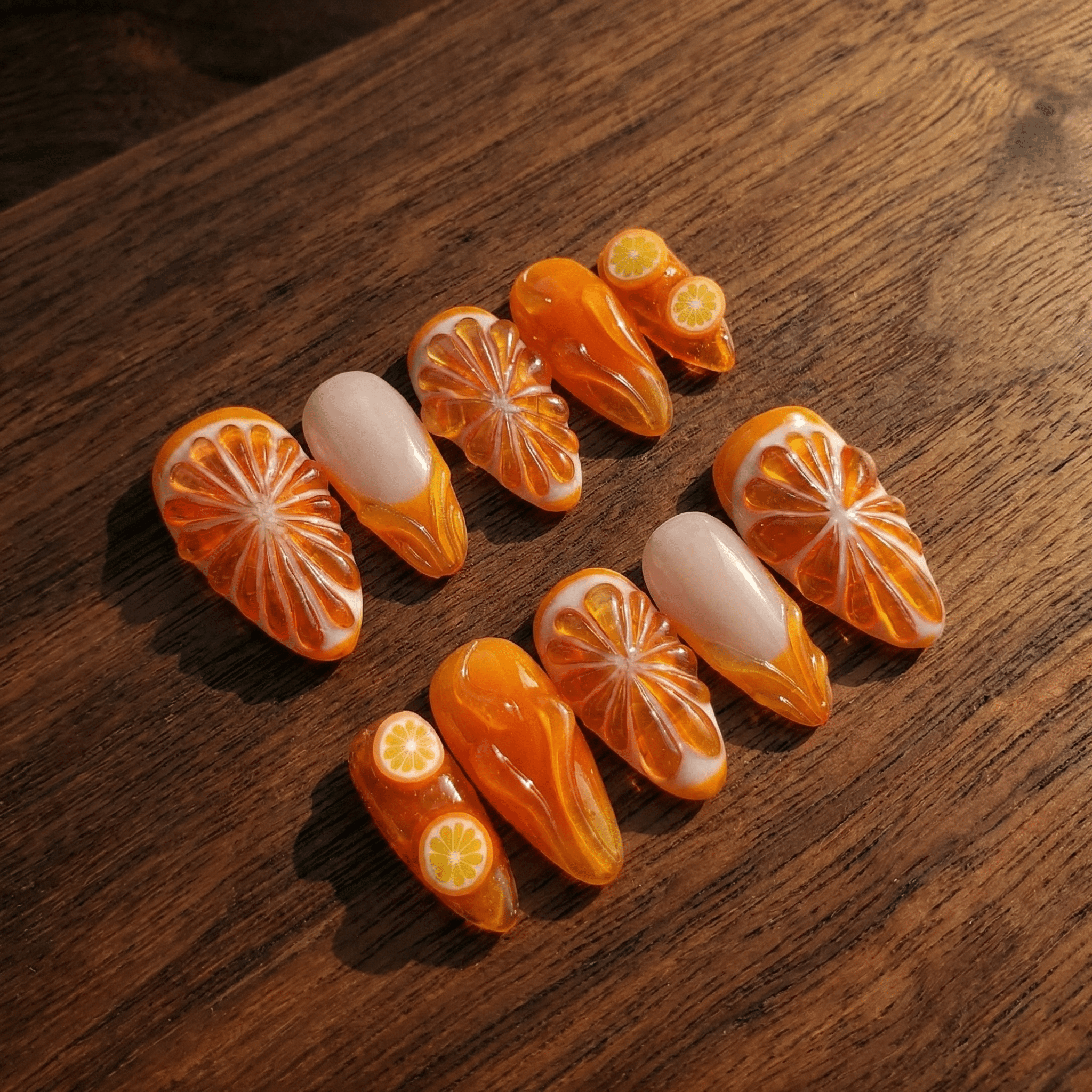 Citrus Glow press-on nails worn on hand – almond shape by Handora