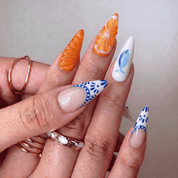 Citrus Voyage press-on nails worn on hand – almond shape by Handora