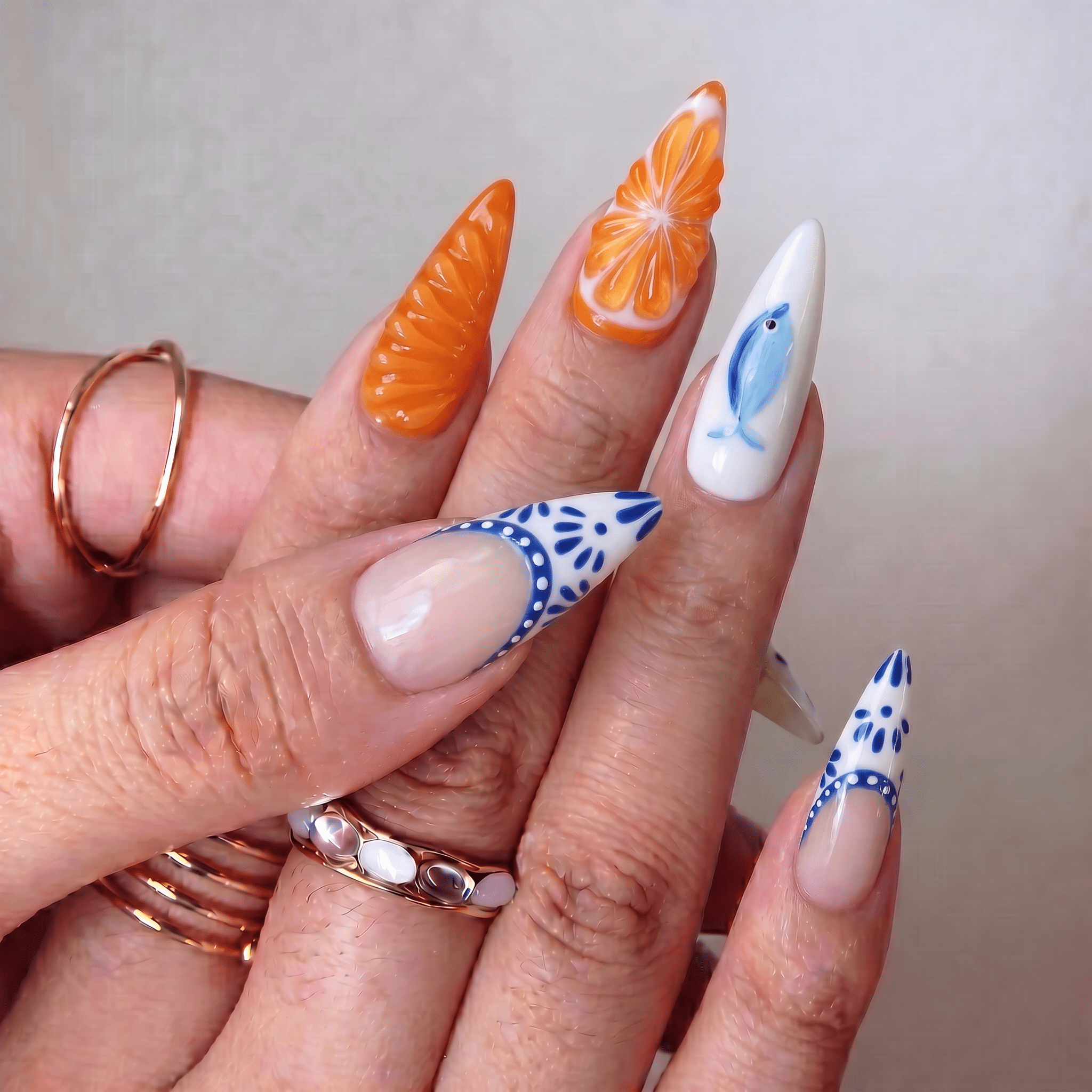 Citrus Voyage press-on nails worn on hand – almond shape by Handora
