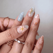 Coastal Wonders press-on nails worn on hand – almond shape by Handora